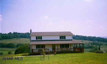 New 2 story white Colonial with wrap around deck.