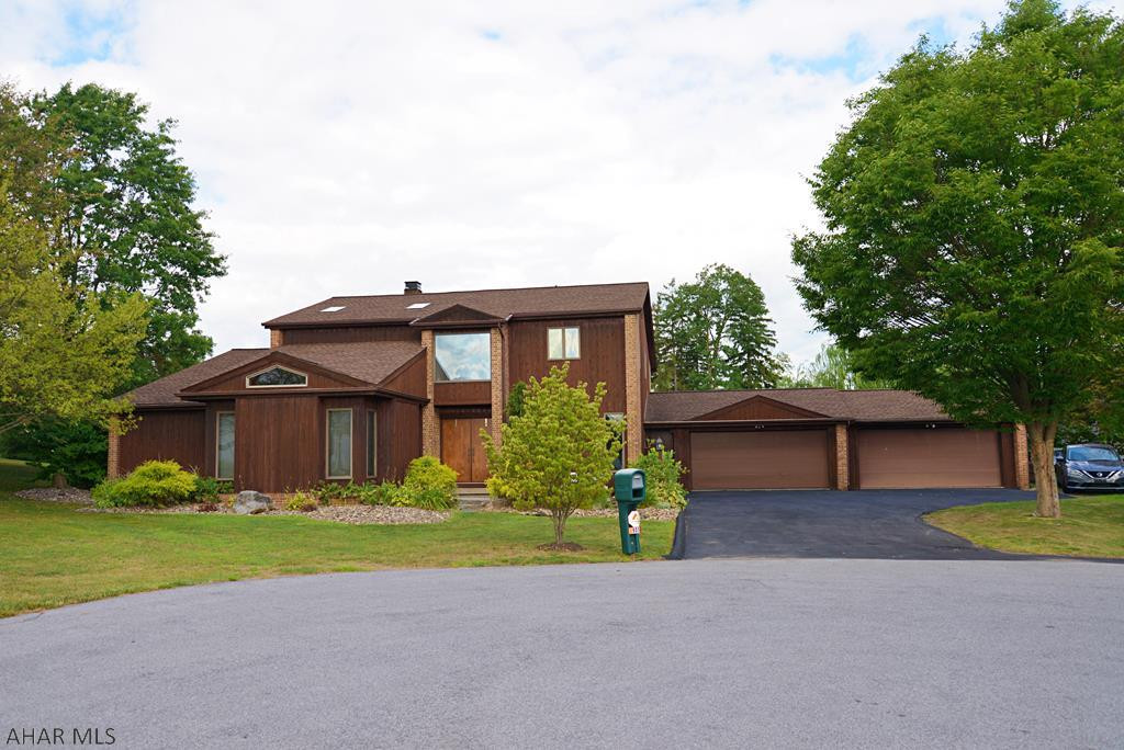This home on the end of a quiet cul-de-sac is a must see! There are two master suites with one on the main level currently used as a private in-law suite with its own kitchen and dining area, sauna, steam shower, sunken tub and direct access to the patio. The great room has a soaring two story fireplace and a large loft over looking the space which makes a great home office. The spacious kitchen is open to an enclosed all season porch with a pellet stove back. There is even a dedicated exercise room on the main level complete with mirrored walls. The outdoor space is where you will want to spend your summers in the heated in ground pool with a waterfall, hot tub (even in the winter), cabana and half bath. Four car heated garage. Call the listing agent today to schedule a private tour.