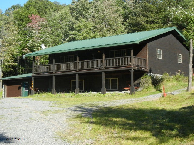 Just far enough out of the city!! Beautiful one story home surrounded by ten acres of woods. Enjoy all of the wild life and the quiet setting. Two bedroom and one bath.  Basement is fully out of the ground and could easily be partitioned to make two bright bedrooms and a full bath. But with ten acres you can expand as much as you want! The kitchen and bathroom both have cherry cabinetry and ceramic tile floors.  The deck has composite flooring and the roof is metal.