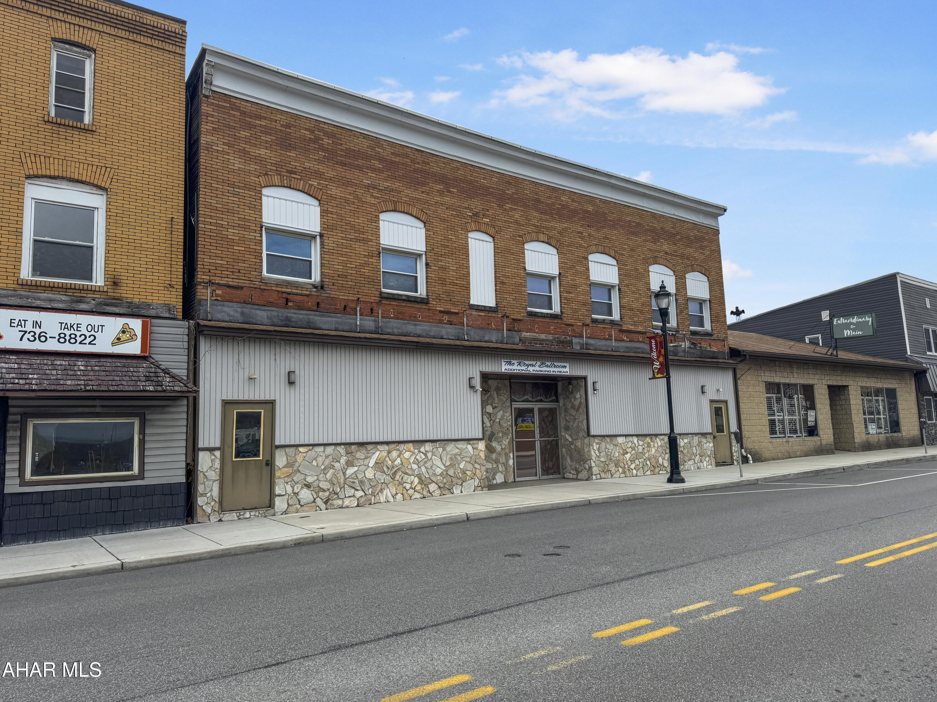 Welcome to 701 Main Street, a prime commercial opportunity in the heart of Portage! Currently operating as the Royal Ballroom, this expansive 15,500 sq. ft. building offers incredible versatility & potential for future development. The main floor features a grand ballroom, full-service kitchen, bar, two restrooms, & abundant storage, perfect for hosting events or transforming into a new business venture. The second floor is fully framed for five 1-bedroom, 1-bathroom apartments, offering excellent income potential, while the spacious unfinished basement provides endless possibilities for expansion or additional use. Conveniently located adjacent to a borough-owned parking lot, this property also includes all furniture, equipment, & the established book of business. The Royal Ballroom will continue operating as usual until further notice, making this a turnkey investment with both immediate returns & long-term growth opportunities.