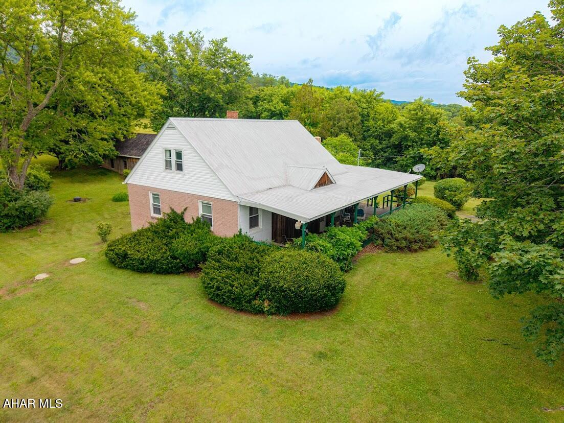 This Home Sweet Home, Move-in-ready brick Cape Cod home situated on 2.9 scenic acres, offering the perfect blend of country charm and convenience. This inviting home features 4 bedrooms and 1 full bath, with a warm and welcoming family room showcasing beautiful natural woodwork, abundant natural light, and a wood-burning stove for cozy supplemental heat.

The spacious country kitchen offers ample cabinetry, generous counter space, and a convenient breakfast area, while the separate dining room provides an ideal space for family meals and entertaining. The main level includes additional living room/foyer and two comfortable bedrooms and a full bath. An open staircase leads to the upper level, offering an additional bedroom, bonus room, and plenty of storage space.

Step outside to the covered front porch and take in the peaceful countryside, featuring picturesque farmland and mountain views. The property also includes an oversized bank barn-style 2+ car garage with abundant storage, a large carport/equipment storage area, and a chicken coop--perfect for those seeking a rural lifestyle.

Conveniently located with easy access to the amenities of Bedford, PA, and Cumberland, MD, this property offers the tranquility of country living without sacrificing convenience.  Great place to start your Hobby farm today!!