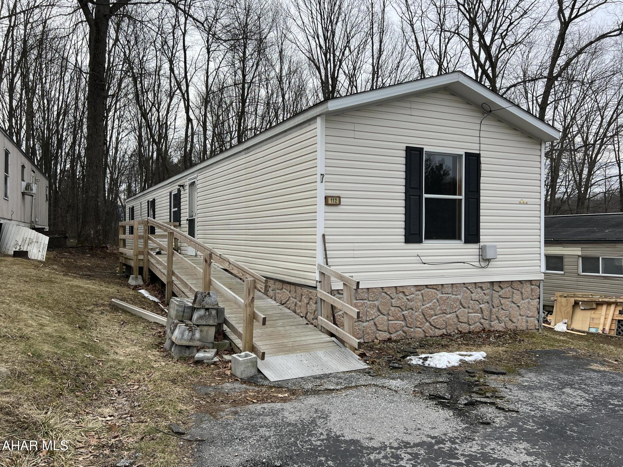 Located in the Pinecroft Mobile Home Park in Antis Twp. is this 2000 Fleetwood single wide with new roof, new carpet in the bedrooms, new vinyl plank flooring in the kitchen and interior is freshly painted. Also includes C/A and furnace is approx 5 years old. Ramp access to main front door. Lot rent is $330/month, includes sewer and trash. Must pass background/credit check. One owner is a PA Licensed Real Estate Agent.