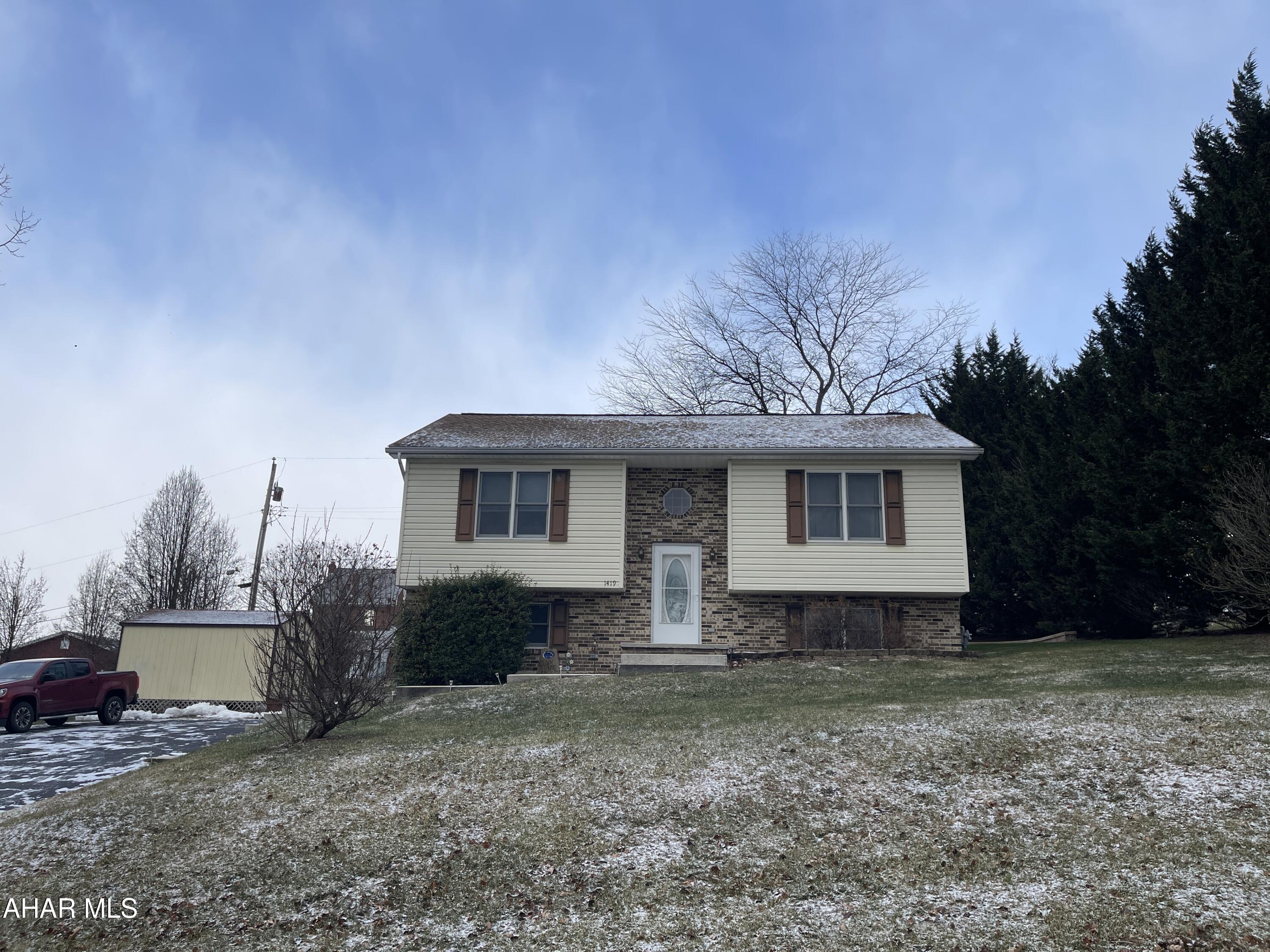 Meticulously cared for Bi-Level home on a large lot.   Kitchen is inviting and easy to prepare food for all of your guests, and includes the SS appliances as well.    The Dining area walks out to an AWESOME all seasons room with a gas mounted wall heater.    This home offers 2 Bedrooms and one full bath on the main level.  Basement offers a nice Family room w/Gas Fireplace and another full bath, and bedroom.   Lots of storage in this home.  When you're in the basement - open the door under steps - it not only goes under the steps, but.......then goes beyond that as well.  Beautifully sculpted ceilings and lots of ceiling fans as well - while still offering Central Air!  There is a very nice paved Patio area as well just off the All Season room for grilling out w/friends.  Also has 2 sheds on the property and abundance of off street parking.