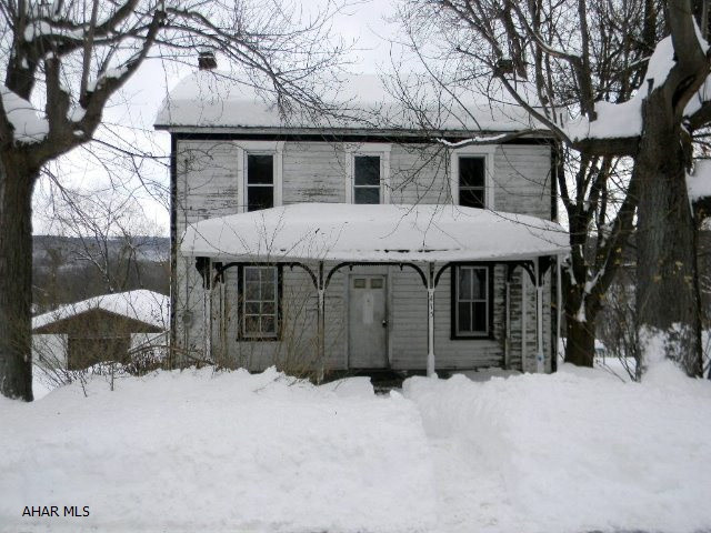 Two story frame house with 1-car detached garage on approx. 1/2 acre lot in Manns Choice Borough. Full unfinished walk-out basement, public sewer, no central heating source. Offered AS-IS. Immediately available.