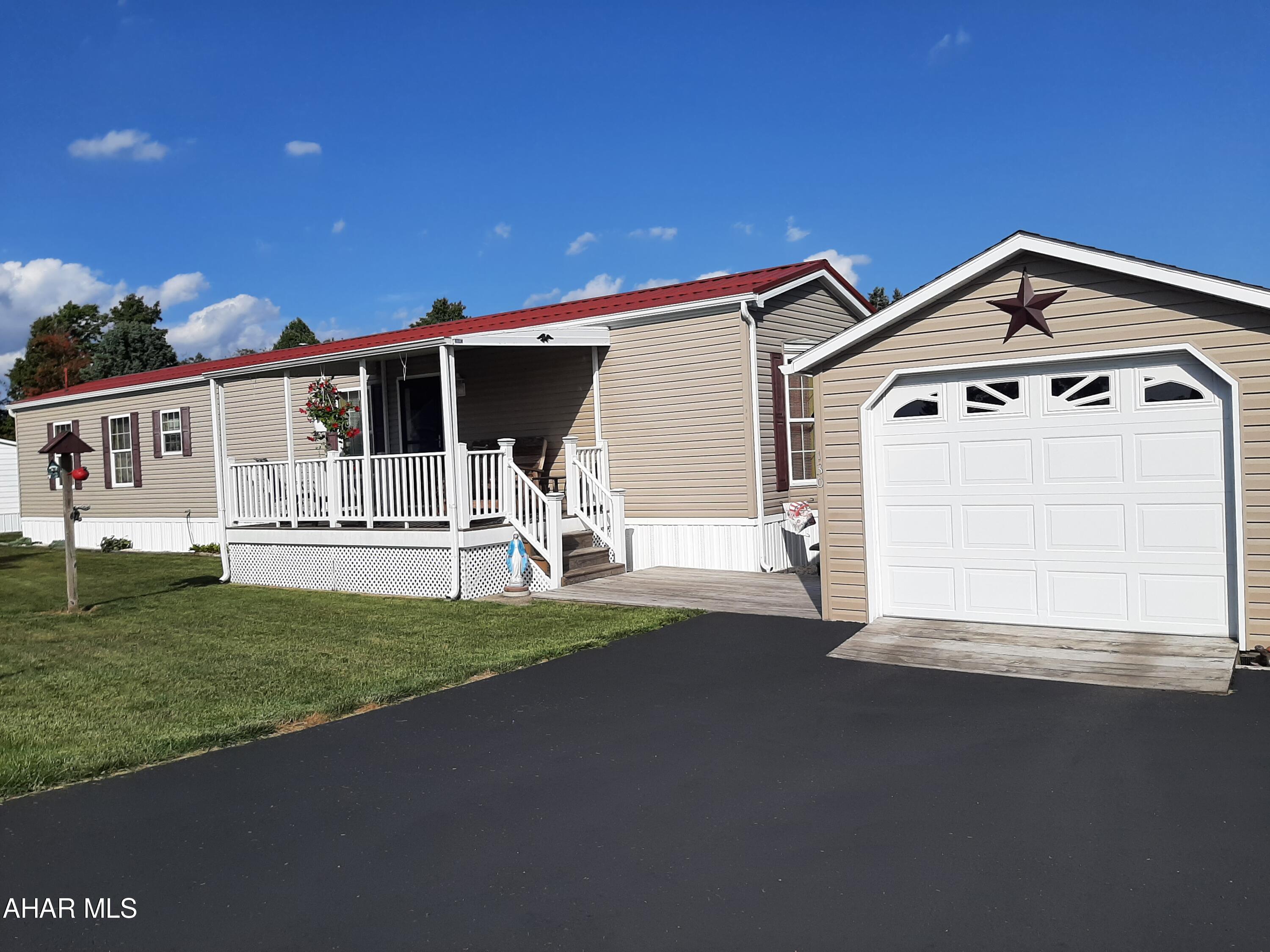 Welcome to this charming mobile home, nestled in a serene mobile home park that offers peace and tranquility. This inviting residence features a spacious covered front porch, perfect for enjoying your morning coffee or unwinding in the evenings. With ample space and a detached garage, you'll have plenty of room for parking and storage. Embrace a relaxed lifestyle in this cozy haven, where comfort meets convenience. Don't miss your chance to make this delightful property your own!