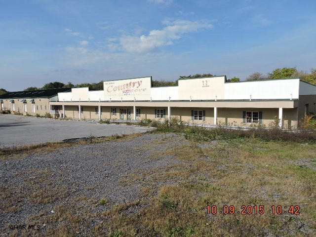 Multi Use Bldg has warehouse space, office space, retail space, and a residential apartment.  4 loading docks, 2 garage bays, plus 24x46 heated detached garage with overhead door.  Office consists of 11 rooms including reception areas, private offices, conference room, break rooms, and rest rooms.  Warehouse has its own rest room and store has its own rest room.  Zoning permits many uses.