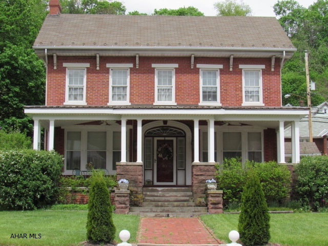 Seller Says Price it to Sell!This unique 4BR,4BA,4 Fireplace brick home with its newly added welcoming Amish built porch  & its 2 car detached garage is priced to sell.This home has many possibilities: a single family home, bed & breakfast, or combination single family/business by using the back area of the main level currently being used as an office with a full bath and laundry area, could be turned into a Hair Salon, Retail Business, or other income producing endeavor. The lower level of the home could be rented as an apartment with its own separate entrance equipped with kitchen, living room, bedroom and full bath. Amenities: Original hardwood floors, crown moldings,arched doorways,bay windows, builtin bookcases etc.. Close proximity to I99 between Altoona, State College, & Huntingdon