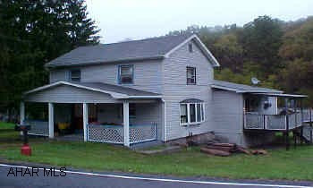 This property offers 134 acres with mountain views, seasonal mountain streams, and abundant wildlife. Property adjoins State Game Lands. Approx. 70% of ground is wooded and 30% is tillable. The home has some new updates including a kitchen, shingle roof, family room, vinyl siding, and furnace. Hunter's Paradise.