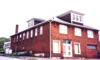 large 3 story with huge store front, 2 large apartments, Great for commercial investment. Motivated seller property in need of new roof, seller willing to make allowance for roof.