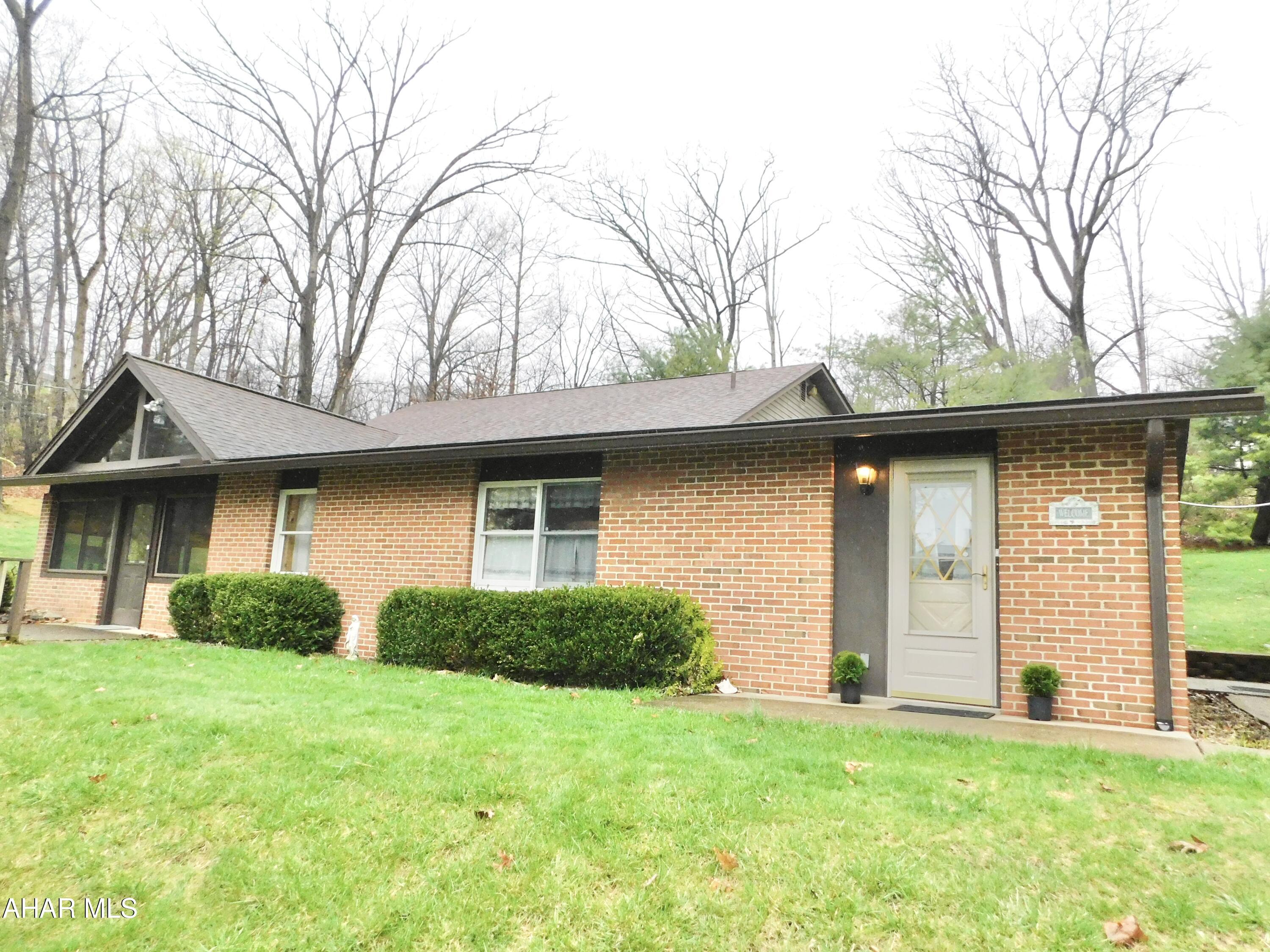This home is so much larger that it looks! This 1 story home offers an additional 2-story addition with so much space. 2 Bedrooms on main level and bedroom on 2nd level could easily be converted to 2 large rooms plus tons of storage and a huge walk in closet. There are so many closets - no lack of storage. Updated kitchen and baths and meticulously kept inside & out. Don't miss the 3-season room with heat source to use year round if desired. There is an additional lot available to purchase if buyer has interest. Situated on a large lot with french drains and plenty of privacy from surrounding wooded areas. The Carport is wide enough for 3 cars.