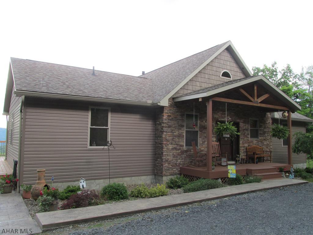 Gentleman's farm with a million dollar view!!  Gorgeous open concept home, stacked stone & vinyl exterior.  Great room w/cathedral ceiling, beautiful stone fireplace (propane), tile flooring "looks like hardwood", first floor laundry.  2 Full 1 half bath main floor, half on lower level (need shower installed).  Property is currently all electric - geothermal wells installed for radiant heat in floor - both levels.  Need pump system - heat pump for heat & air.  Stainless appliances, 2 barns, 2 pastures - see additional info - salt water pool