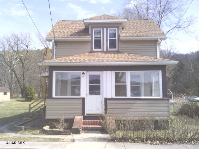 Spring Cove School District. This 2 story home features knotty pine kitchen w/tile floor, 1st floor laundry w/1/2 bath, 3 bedrooms, living room, 3 season room, new windows, roof, siding, water treatment system, shed and pond, sitting on over 1/2 acre.