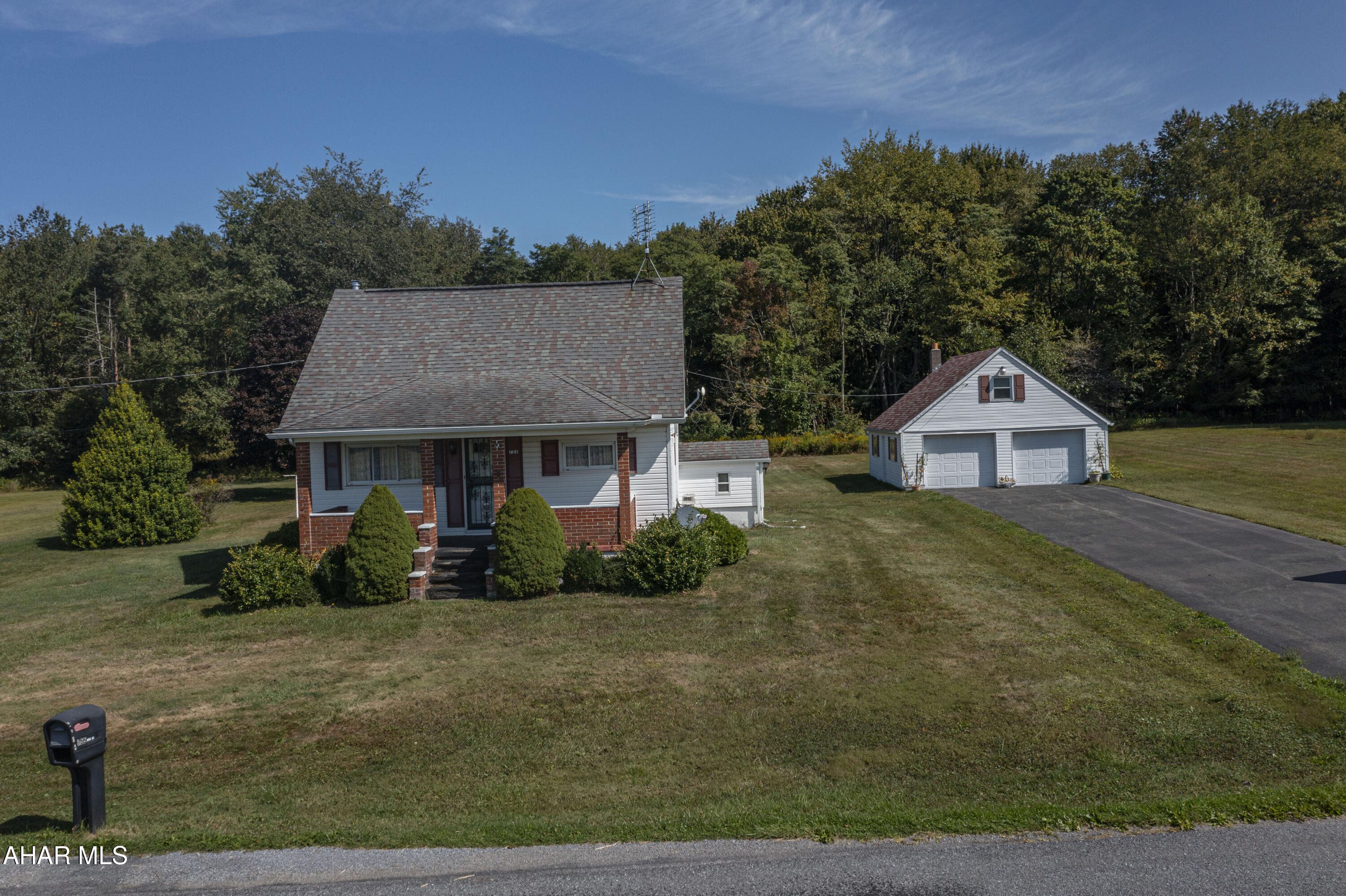 Quaint two bedroom one full bath home situated on 20 acres . This home features 2 large living rooms and a full bath and a spacious eat in kitchen on the main level . Second floor features 2 bedrooms. Outside a large 2 car garage a beautiful yard surrounds the home. Schedule a tour.