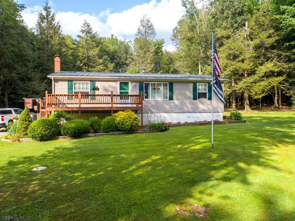 If you are looking for a more private setting, this meticulously maintained property that sits back off of the road on approximately seven beautiful acres is the one for you. House is perfect for entertaining family and friends, the kitchen is open to the dining and living rooms, and the basement has a bar area with half bath that is sure to please the guests. The fire pit in the back yard is the perfect center to make mountain pies while enjoying all the wildlife. Fenced area for pets, detached garage to store toys. Many newer updates to this property, new roof in 2015, remodeled kitchen and bath, new hot water heater 2016, new laminate wood flooring throughout upstairs. Seller is subdividing land. House/garage will be on approx 7 acres. Seller would consider selling additional acres.