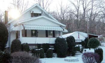Logan Twp.  1 1/2 story home on 1.37 acres. Screened rear porch, garage & carport.