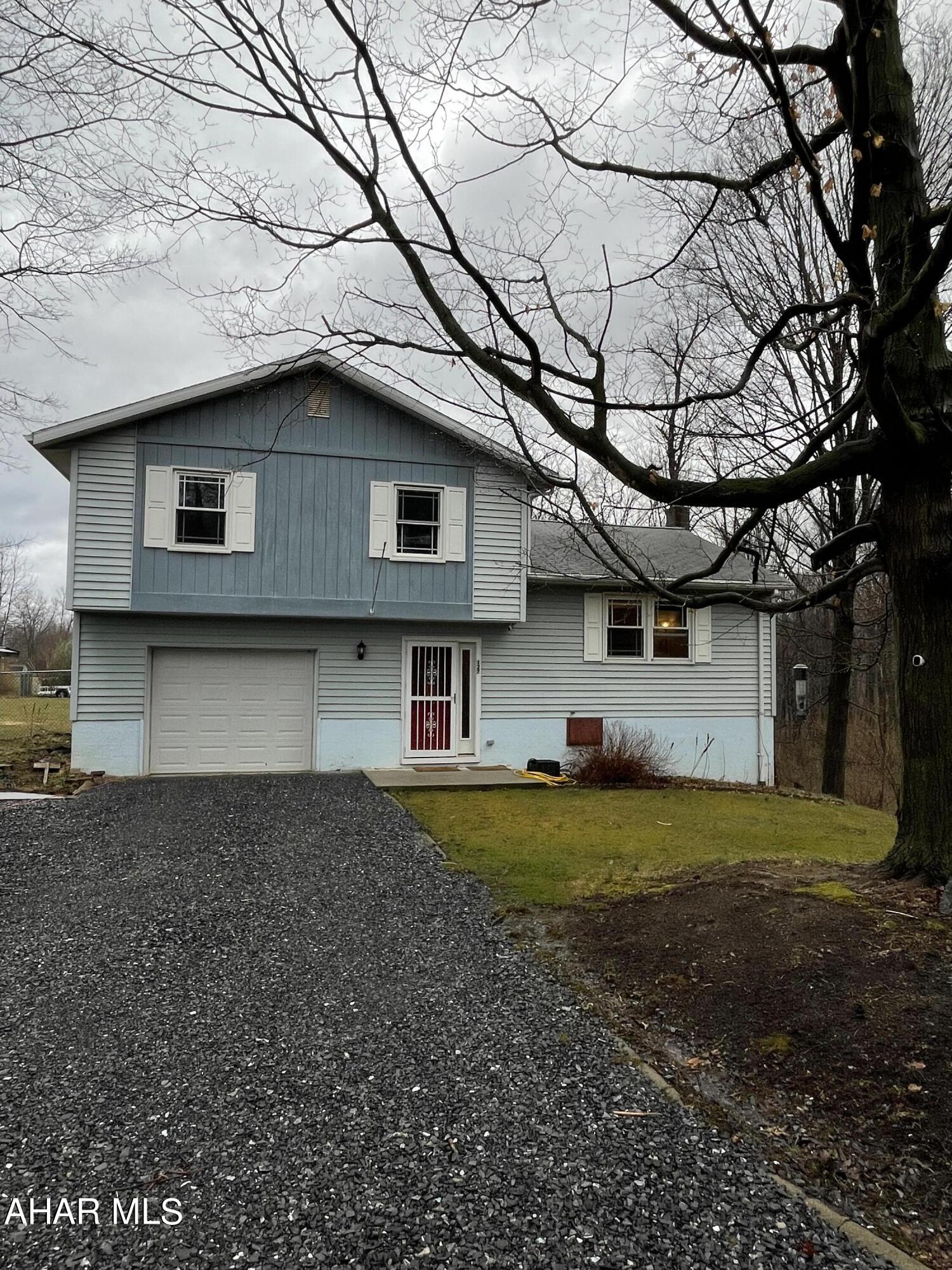 This well maintained 3 bedroom 1.5 bath split level home sits on 1.25 acres right outside Roaring Spring!  Enter the foyer to remove shoes and coats, this level also features laundry.  On the second level you will find a large living room and an eat in kitchen that does include appliances.  On the 3rd floor you will find 1 full bath and 3 bedrooms, Master bedroom has a half bath with potential to install a shower.  Some newer floors, and new parts for the central Vac system.  Several outside features include a large fenced area for all your critters two large gates on ends of fence to pull in vehicles, there are several fruit trees including a peach tree, large covered deck great for entertaining family and friends, an integral garage and a separate garage/shed for all your outdoor items.  Nice private setting.  Call today!
