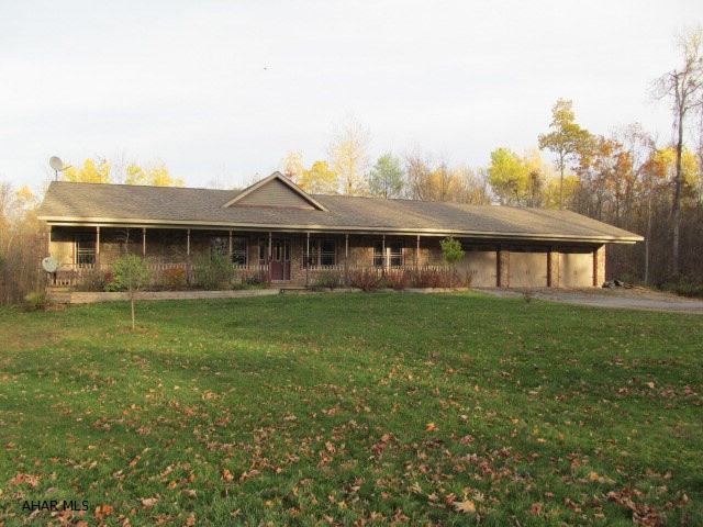 MOTIVATED SELLER. Enjoy your privacy in this spacious, custom built ranch home on 3.8 acres.  Features an open concept floor plan with vaulted ceiling in LR, open to kitchen/dining area.  This home would be great for indoor and outdoor entertaining with 2-tier deck with hot tub and large front porch.  Engineered hardwood and ceramic tile throughout. Energy efficient heating system with radiant floor heat, heat pump and central air.  Lower level is partially finished and by just adding some flooring, would make additional living space.  There's also a 2-car integral garage and 3-car attached garage with 8 ft doors, both with hot & cold running water.  Public water and sewer is an added plus. 15 mins. to Tyrone, 30-40 mins. to Altoona, and 45 mins to State College. BRING OFFERS