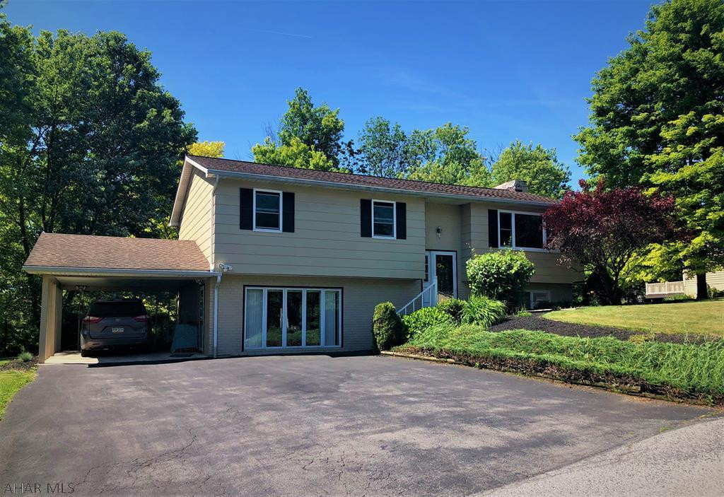 Beautifully maintained 3 bedroom 2.5 bath bi-level home in Hollidaysburg Area School District. The location is conveniently close to Altoona/Hollidaysburg/Duncansville area but also in a small private neighborhood with no through traffic! This home is move-in ready featuring laminate flooring throughout, skylights in the kitchen/dining room area, heated tile flooring in 2 of the bathrooms, full finished basement with 2 living spaces that could be used for many purposes, & access to the screened-in sun room from the kitchen with a relaxing view of the large flat backyard. BONUSES: There is a separate entrance to the basement from the carport that can be used for a small business & there are solar panels on the roof used for energy-efficient electricity! Come check it out for yourself!