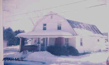 Lovely & sapcious home in excellent condition hardwood floors, sunroom, new windows, large level lot, large garage, workshop