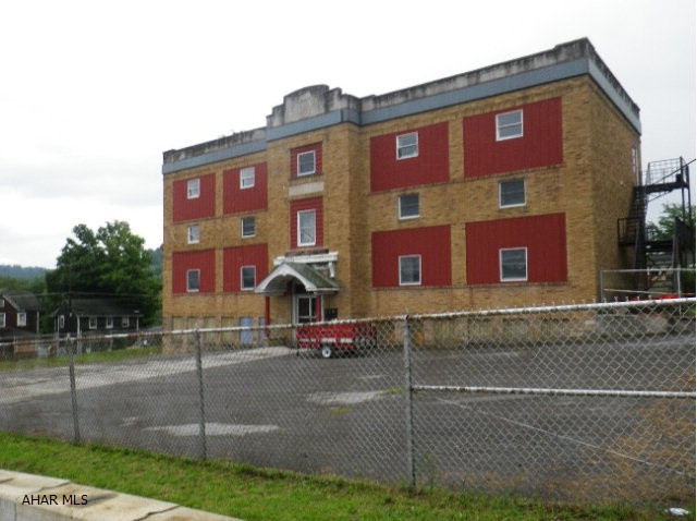 6 unit apartment building, Brick. 5 apts remodeled. Newer roof. Enormous parking lot. Fire escape. Has Severe Mold Damage! Anxious seller.