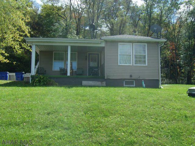 Charming cottage style ranch offers country quiet, but is only a few miles from town.  Backed on 2 sides by woods allows for privacy, and you can sit on the front porch and enjoy lovely views.  Open concept kitchen / living room allows you to arrange the space to your needs.  Two main level bedrooms with the potential for 2 more down stairs. Double your living space with a fully finished basement.  L-shaped family room has a 3/4 bath and outside entrance.  Add a kitchenette and you've got inlaw quarters!  Two car garage.  Shed with porch.  Tons of potential!
