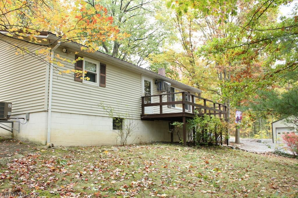 Well maintained ranch home in a gorgeous wooded setting.  Two bedrooms, 2 baths,  full basement, new heat pump, new hot water heater, 2 freezers, kitchen appliances, fully furnished, lawn tractor, generator all on 18+ acres.  Very large two car detached garage with new insulation and drywall.