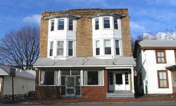 3 story frame and brick commercial building, Finished all three floors. Large oven and wall air-conditioning units stay.  2 gas ranges and freezers do not stay. Former St. Vincent DePaul family kitchen.  Second floor 5 finished rooms and bathroom.  Third floor 3 rooms and 1/2 bath.  2 gas boilers, 3-100 CB electric services.  2 car garage.  2 gas ranges and freezers do not stay.