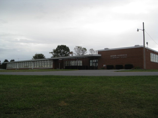 Former Mann Monroe Elementary School. Building is in excellent condition and has many opportunities. Contents to be sold at public auction but all fixed items will remain. 65% of the building has a new roof. Oil hot water heat with air conditioning units in former classrooms and office. Large kitchen and cafeteria/auditorium area. Large parking area. Building may not be purchased to be used as an educational facility.