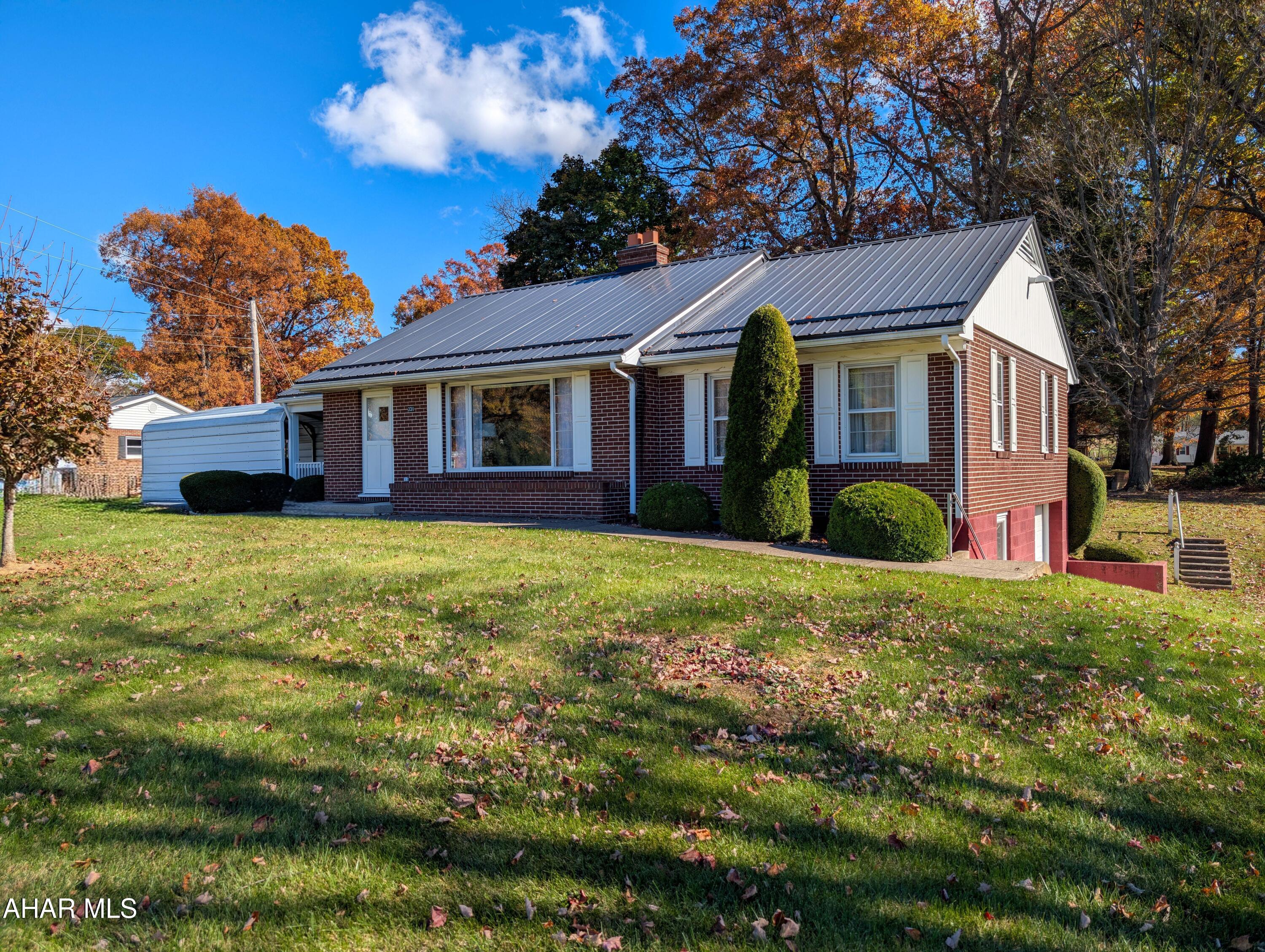 Solid Brick Ranch Home on .86 acres. One floor living , perfect for the couple just starting out or anyone looking to downsize and get rid of steps. Has a brand new metal roof, carport and an integral garage. This home has been lovingly maintained. Could be 3 bedrooms, but currently 1 has been converted to a main level laundy room. Cozy kitchen with new refrigerator, Dining area , living room with a wood burning fireplace for those cold wintry days. Basement has plumbing for a second bathroom. Heat is oil forced air along with central air. All furniture and appliances could be part of the sale. Lovely location, with level lot! Call to see this one in person.
