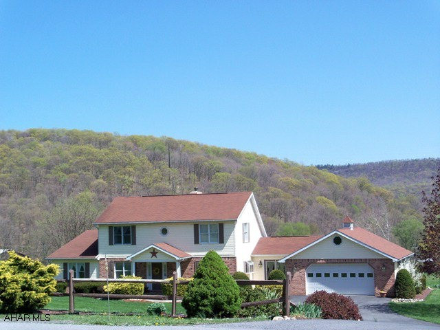 This pristine home offers generational living with lowest level walking out to ground level and boasting a large FamRm area, newer and full bath, two bedrooms, full kitchen, laundry facilities!  The main level has a huge 30x15 MBR with a private, large MBath plus a walk-in closet/sewing or bonus type room area!  Really unique interior with beamed and vaulted ceilings, a stone fireplace with wood insert, walls of windows provide beautiful mountain views, formal DR, light and bright Kit, plus a Gathering Rm to welcome guests!  Manicured yard, plenty of perennial beds, fish pond w/waterfall, gazebo, attached 2 car garage!  Central air, paved drive, newer deck!  Truly move in condition!