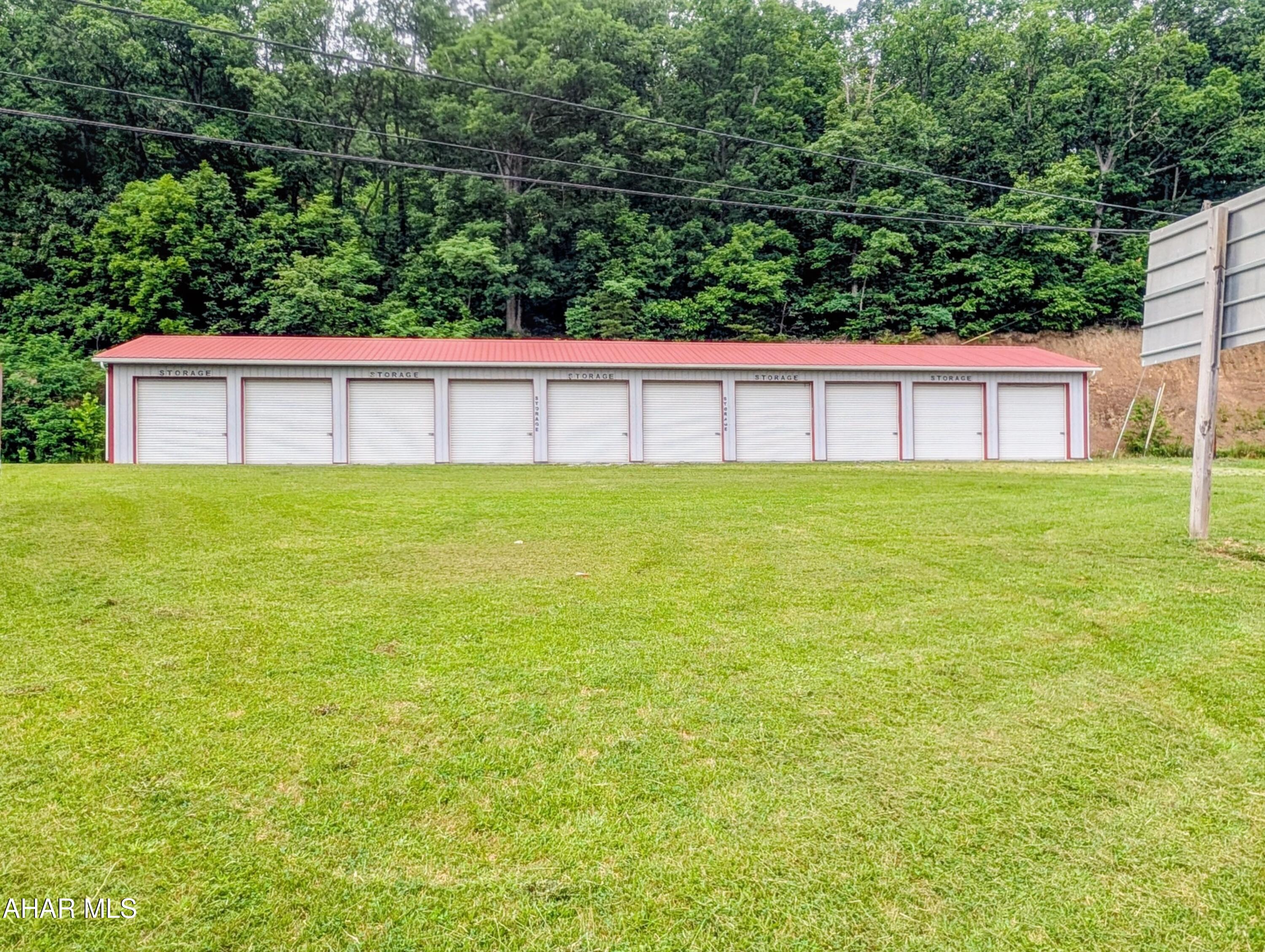 Hard to find storage units for sale.  These are located along Rt 30 just East of Everett. Building is 2592 square feet and divided into 10 units with dimensions of 12X24. Metal building with a steel roof. Building was built in 2007.  No utilities are provided. Property does not have water/septic or electric. All unts have overhead doors with each tenant having their own lock. 
Billboard on property that is rented as added income at $750 annually. 
Sellers have a waiting list of potential renters waiting for a unit to become vacant. Don't miss out on these storage units!