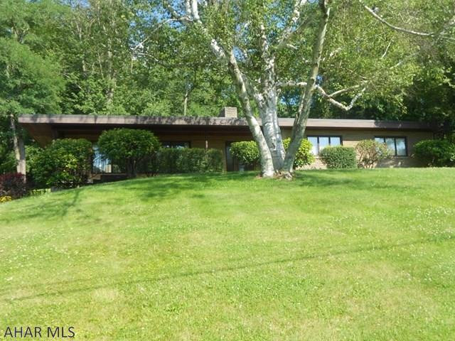 Unique style home custom built in 1959. This is one of the great parts of Bedford to raise your family or sit back and enjoy life. 3 bedrooms and 2 baths, family room with wood fireplace. An inviting sun porch. Living room is large with big windows to enjoy the natural light and outside views. 2 car integral garage. Close to golf course and school. Come take a look and see for yourself.