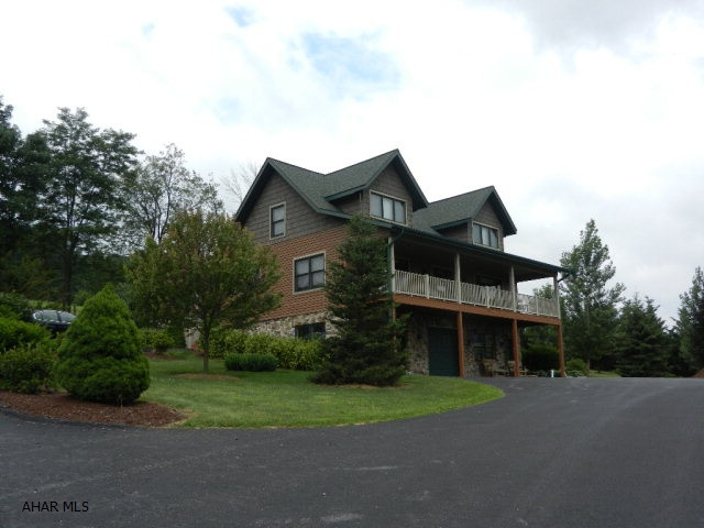Rustic elegance in this 2 story lodge like, 4 BR/4 BA home situated on a 119 ac. adjoining Buchanan State Forest (13,000 ac). This spectacular home (open floor plan) includes a large, oak, eat-in kitchen, a spacious dining room/living room with hardwood floors and a stone fireplace with wood stove insert Sleep well in the spacious master suite w/ full bath and two large closets. A laundry/half bath complete the first floor. The second floor includes three large bedrooms w/ large closets,full bath and great views. The basement level includes a 2 car integral garage, den/office and 1/2 bath. A detached 4 car garage w/ outdoor furnace on site. Generator hook-up and internet-cell service.