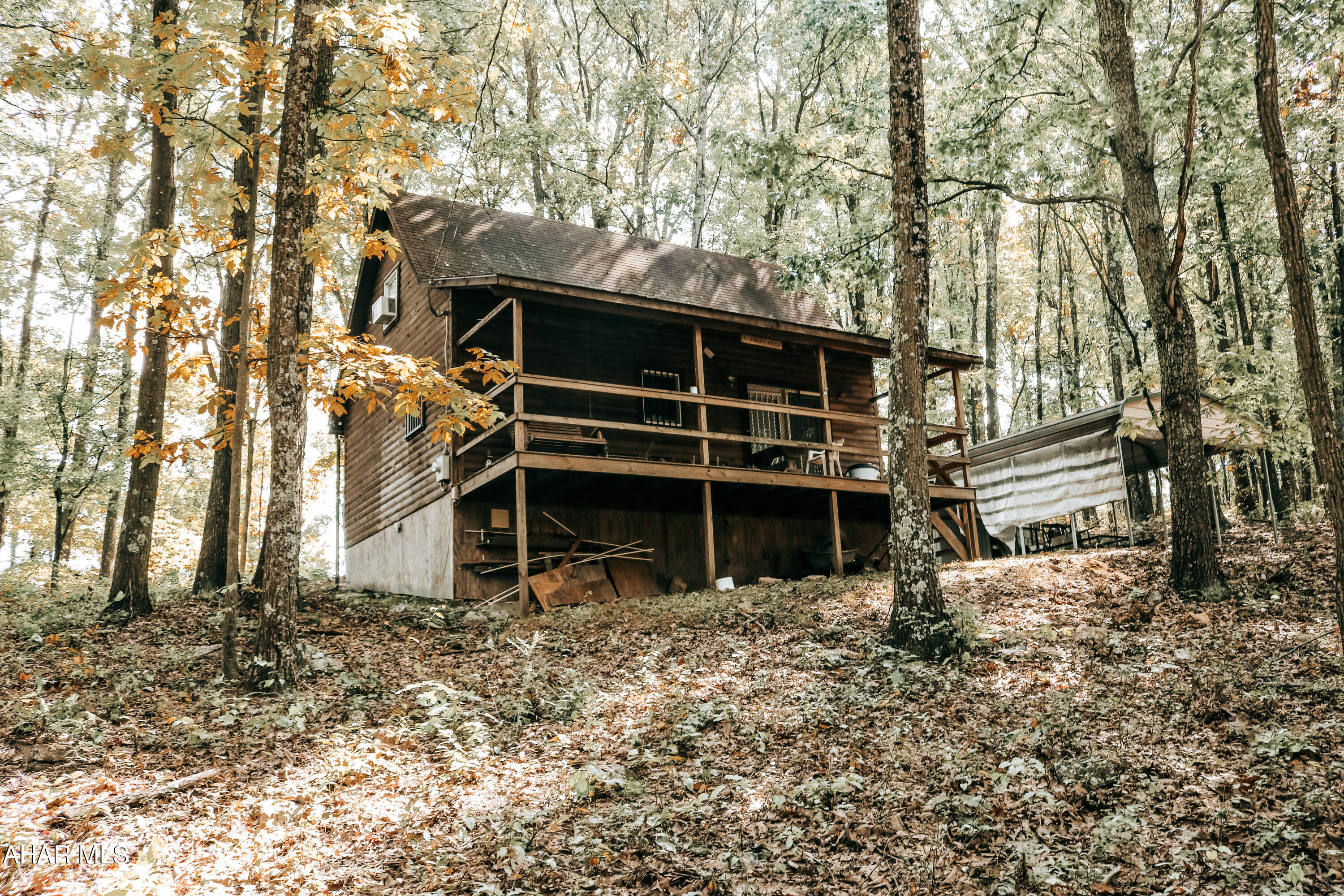 Your house hunting is over! Make this cozy, cabin your full-time residence or getaway!  Beautiful fully furnished home on over 7 acres of wooded land.  Enjoy the views from all parts of the property.  1 bedroom and 1 full bath on first floor.  Large kitchen and living area for gatherings.  Upstairs loft with bedroom and half bath.  Pellet stove in the living room.  Private well and private septic. Carport included to park under and enjoy the outdoors. Be sure to relax at the fire pit.   Just in time for hunting season!