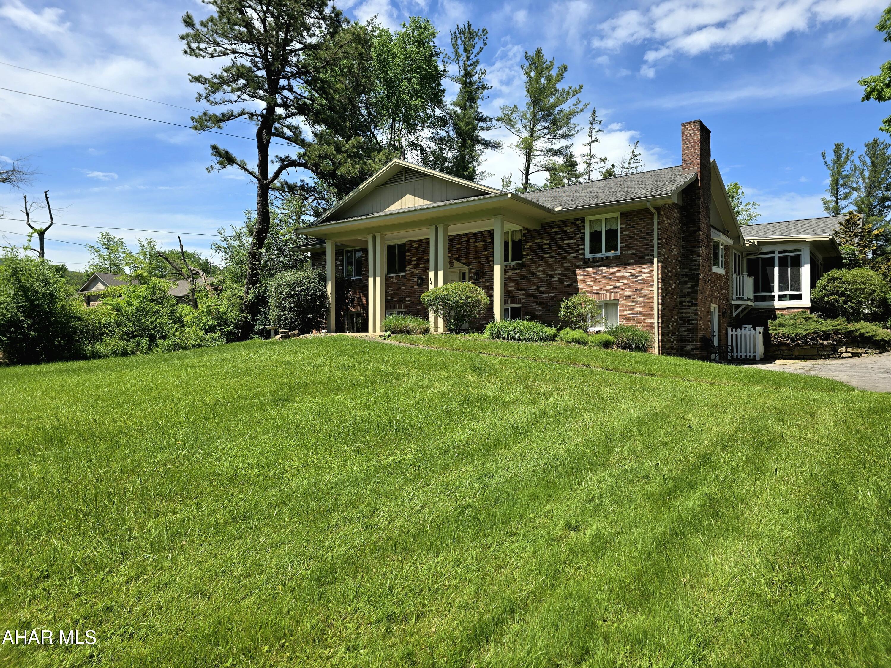 Foot of Ten -Situated on over 1 acre this Duncansville area brick bilevel with fenced in rear yard is waiting for you. This home offers 3 bedrooms, 3 full bathrooms, hardwood floors, 2 fireplaces, large eat-in kitchen with granite counters and high end appliances. The spacious main level has an open floor plan with single story living in mind.  The primary bedroom boasts an oversized walk in closet, and luxury bathroom with both jetted tub and stand-up shower.  The lower level provides comfort with the third bedroom, third full bath, and family room.   Schedule your private showing and see all that this home has to offer.