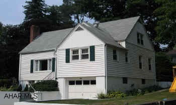 Cape Cod located close to schools and shops. Fireplace in Living Room, thermal glass windows; modern kitchen; hardwood floors, ceramic tile in kitchen, patio in back.