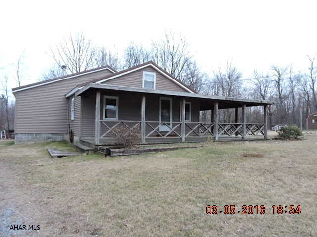 Terrific location and nice lot compliment this 1 1/2 story home.  3BR & bath on 1st floor. Modern kitchen.  Sit on the wrap around porch & enjoy the quiet country.  No heat on 2nd floor to bedroom or bath.  As Is Sale.  Wood burner in basement is not useable.