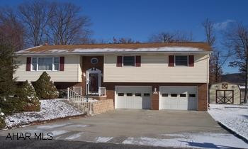 Raised ranch on level lot in developement This home is like new condition with all appliances included.  Large rooms, cherry cabinets, pantry, main level laundry, skylights, ceiling fans, finished basement with hearth for wood stove or pellet stove hookup and a full bath. two car attached garage with 1/2 bath. 12x20 shed. This house also has  gas hot water heat and also a heat pump for heat and cooling...
