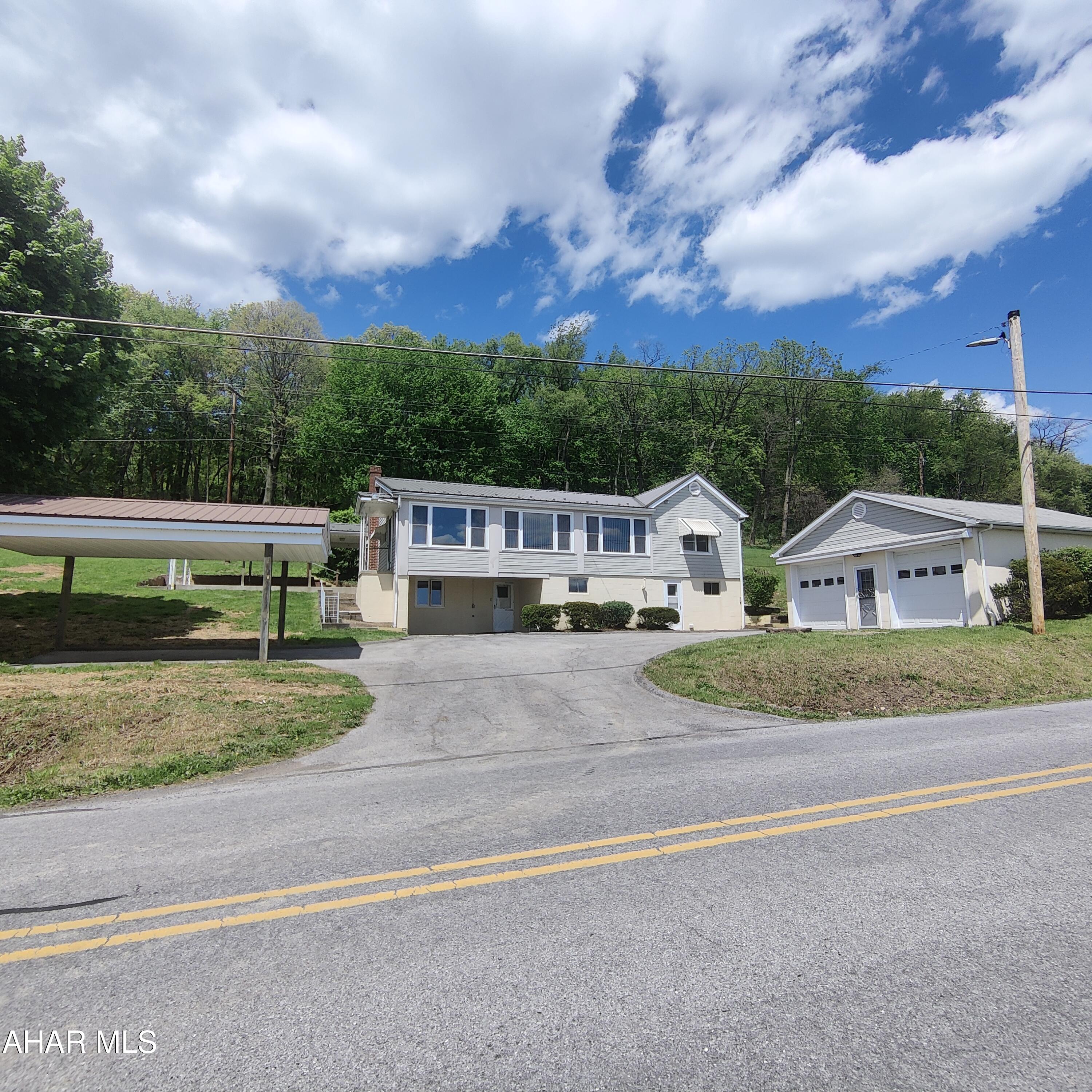 Sweet Spot on Lock Mountain Road with GREAT VIEWS of Martinsburg. Nice Home with 3 BR, 2 Baths, and 2 Car Detached Garage. The 1.5 Acre Lot provides a Nice Place for a Garden or Fruit Trees and a Covered Cement Deck for Eating and Entertaining. Consider the Roomy 2 Car Garage, Car Port, Wood/Coal Stove in Basement for Supplementary Heat, Many Closets, Walkout Basement to the Driveway, Enclosed Back Porch, New Metal Roof on House, Spring Cove School District... And Did I Mention the Views!