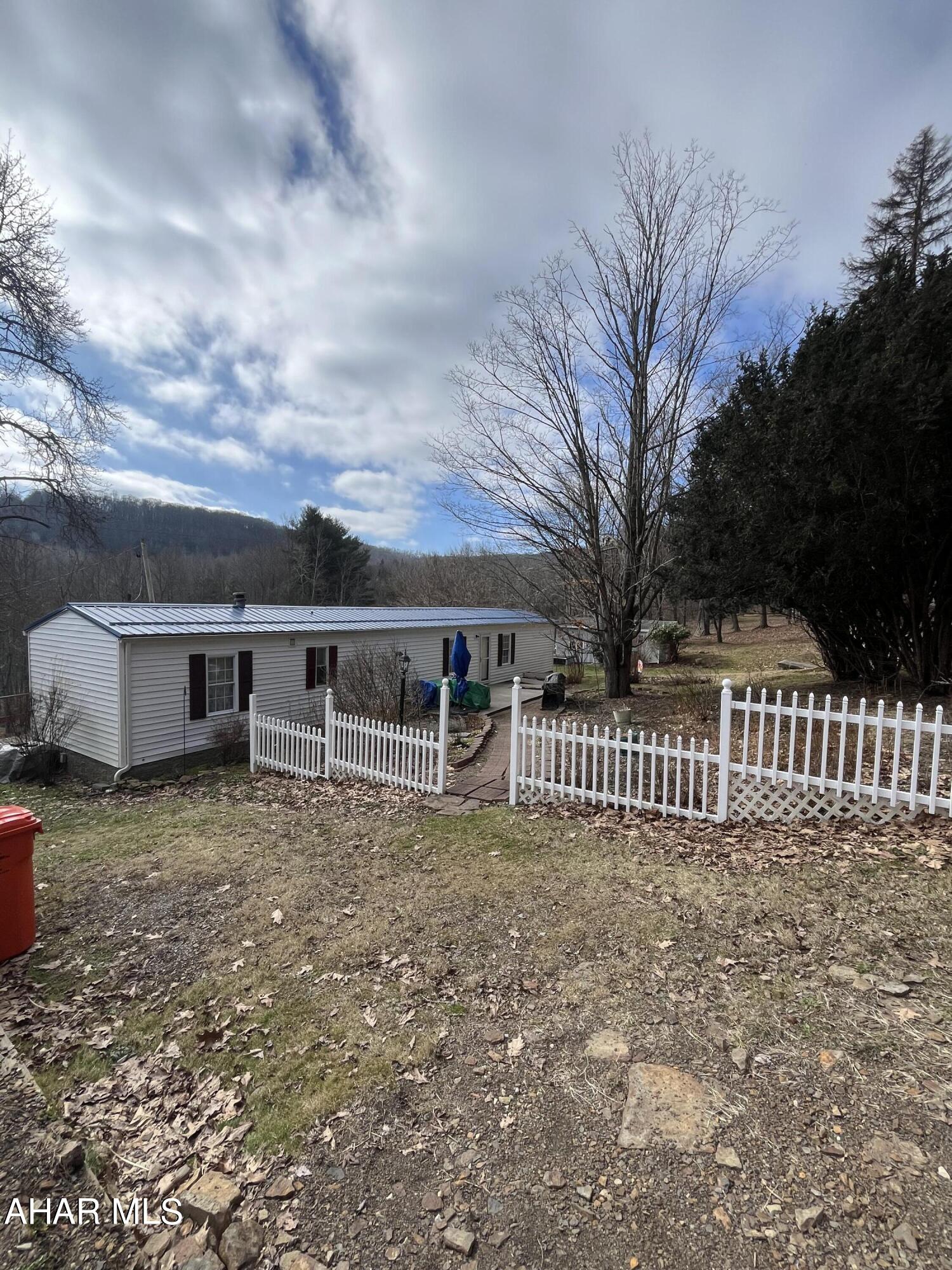 This 20 acre parcel offers privacy & opportunity for a great get-away as a hunting camp. Tons of wildlife and a large fresh water fed pond. Possible timber value and a gas well on the property so you have free heat! Mobile home is a 1994 and very clean - windows and roof have been replaced. There are 2 sheds on property and a spring house. Seller is older and will make no repairs. Seller must secure suitable housing.