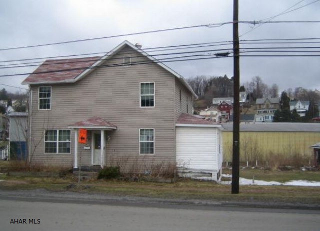 2 story vinyl home in need of work.  1 car detached garage in need of TLC.  Possible flood zone.