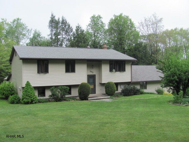 Cambria Heights SD- 3-4 BR vinyl Bi-level on approx 1 acre.  Wet bar in basement. Coal, oil & wood heat. 3 car attached garage & 1 car detached garage.  Great location.