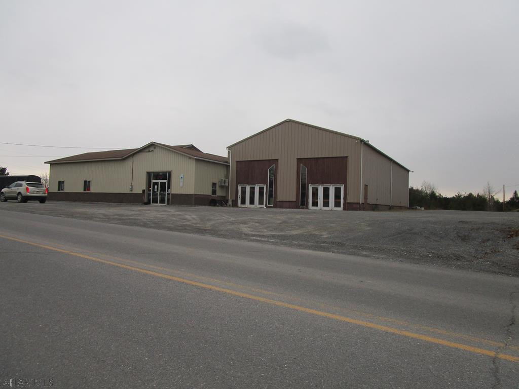 Large commercial building on a high traffic corner lot containing 3.99 acres. Office and warehouse space. Used as mobile home dealer site the building has a large showroom with offices and bath. Heat pump and air conditioning. Unfinished multi use side addition. Large level parking/storage area.  Excellent opportunity to grow your business.