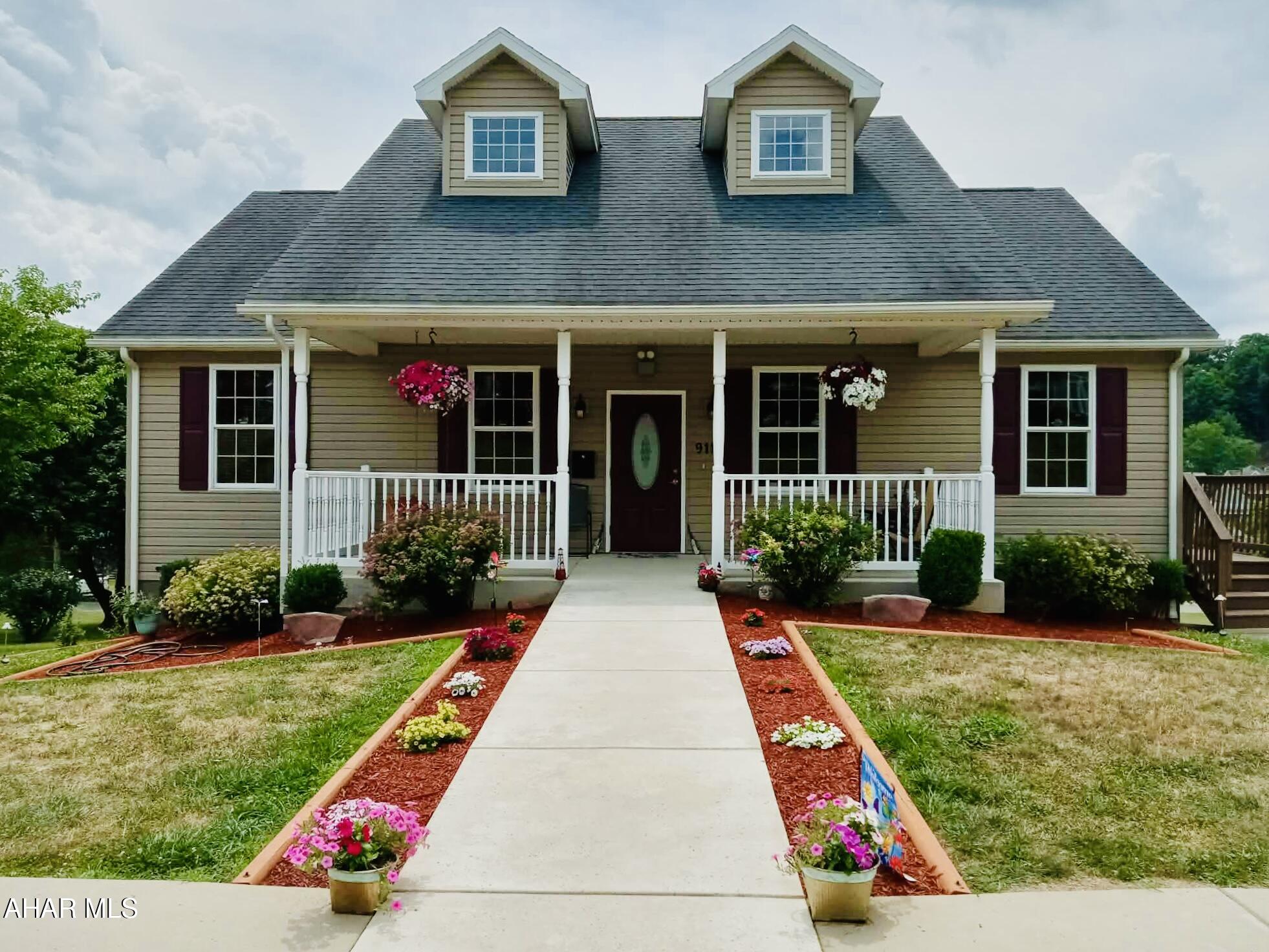 Beautifully maintained Cape Cod-style home built in 2013 on a .34-acre lot minutes from Raystown Lake. The main floor features a spacious open-concept living and dining area with cathedral ceilings, a primary bedroom with en-suite bath, a half bath, and a kitchen with solid cherry cabinetry and a cozy eat-in nook.

The finished lower level offers a large family room, two additional bedrooms, a full bath, and a utility/laundry room with walk-out access to the backyard. Each floor includes separate heating and cooling zones for year-round comfort. Designed with accessibility in mind, the home features wide doorways, extra-wide stairs, and open floorplan flexibility.

A large detached 30' x 40' garage accommodates boats, RVs, or multiple vehicles with 12x12 insulated doors--just 9 minutes to Weaver Falls boat launch and 16 minutes to Trough Creek State Park. Move-in ready with beautiful views and ideal for full-time or recreational living near Raystown Lake!
