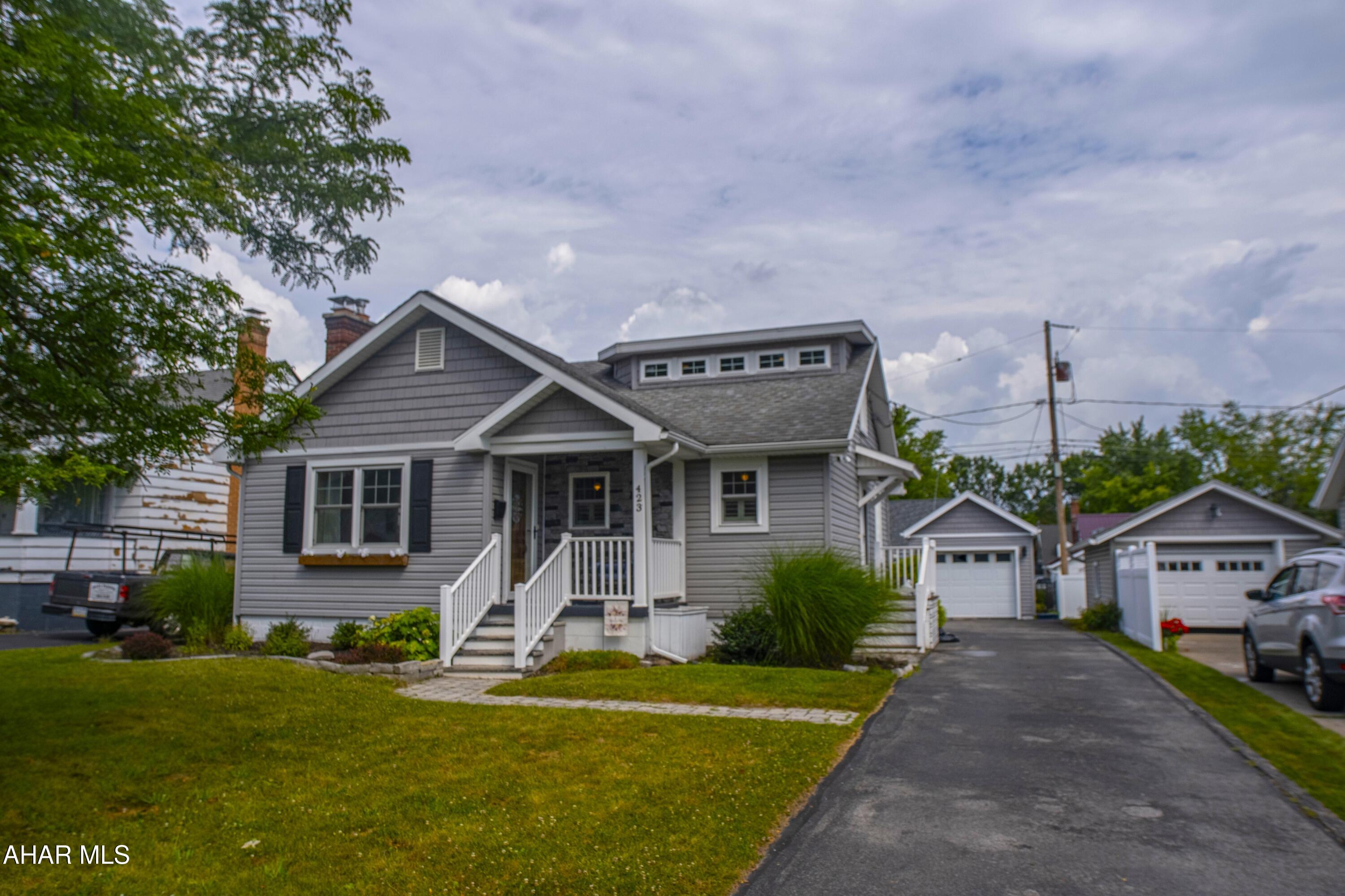 MOVE-IN READY GEM 
IN HOLLIDAYSBURG BOROUGH!! This chic 1 & 1/2 story completely updated home in the sought-after Hollidaysburg Borough is conveniently located in close proximity to C.W. Longer Elementary, Hollidaysburg Jr. & Sr. High, Tiger Stadium, Hollidaysburg Library, YMCA, downtown Hollidaysburg, Legion Park & more! This home features: 3 bedrooms, 2 full bathrooms, the primary bedroom has it's own bathroom with easy access to laundry & a sliding glass door to covered deck - perfect for relaxing with your morning coffee!! The living room & kitchen are open concept & the kitchen features all LG black stainless steel smudge-proof appliances, marbled tile back splash, & Corian countertops. This home also features a spacious finished basement with laminate flooring - perfect for entertaining guests, office space, a playroom, recreation room, etc. There is also a large unfinished room for storage. The detached garage could be used for your car, storage, or a workshop! The fenced-in yard is perfect for your pets!! Schedule your showing today!!