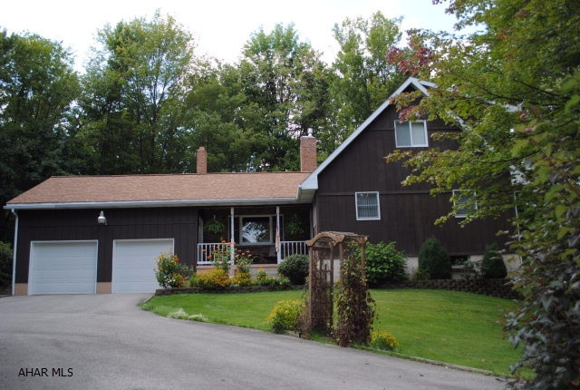Custom Built Bellwood Home on 8.2 acres! This home offers LR w/Beamed ceiling, HWF & floor to ceiling brick fireplace, DR w/HWF, EIK w/appliances,1st floor Den, One story living w/1st floor full bath and bedroom, 2nd floor offer 2 spacious bedrooms and another full bath! Lower level family room w/ wood burning fireplace and wet bar! Plus screened porch and deck area to view the beautiful surroundings!