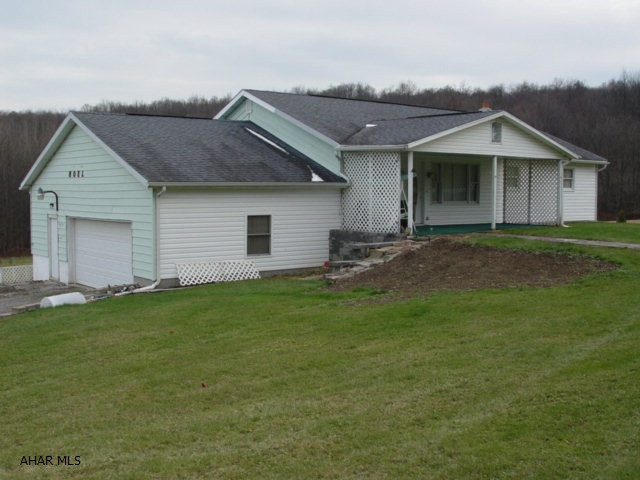 This property comes with 6.9 acres of grass and wooded land.  There are 2 rich soil gardens for planting, huge 2 car garage with working area, all insulated and heated, and a 21x21 aluminum garage for all those extra toys.  In the wooded area there are 2 fresh water ponds and a 12x12 get away man cave. Lots of living space with 4 bedrooms, Open DR, LR, & Kitchen, and lg Full bath on the first floor.  Lots more space in the walk out full basement with 4 large rooms and a 3/4 bath.