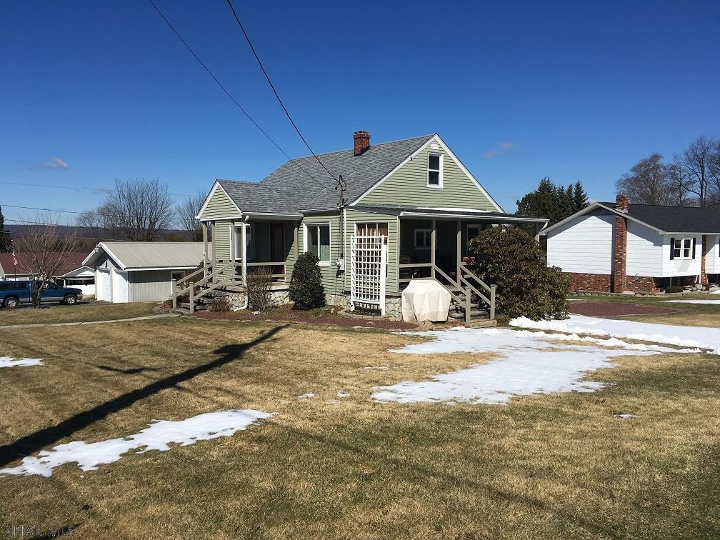 4 BR Cape cod on large lot with newer 2 car detached garage. Wall a/c in living room.