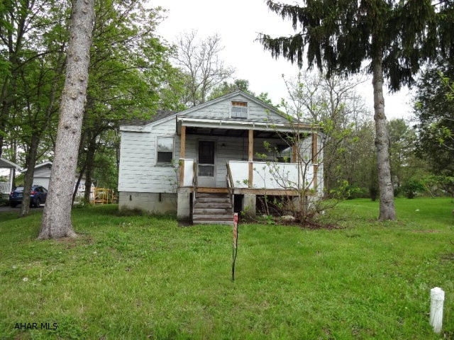 Location, Location, Location- One story house that is gutted with newer roof, porches and electrical service, being sold as-is