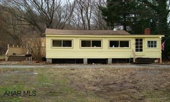 Cottage on 1.44 acres bordering Dunnings Creek in Reynoldsdale.  3 large bedrooms, full kitchen, living, laundry and 3/4 bath. Cottage on 1.44 acres bordering Dunnings Creek in Reynoldsdale.  3 large bedrooms, full kitchen, living, laundry and 3/4 bath.  Large wood stove in living room with oil hot water furnace as well.  Large side deck over-looking Dunnings Creek and a screened in front porch off the front.  Bonus 18x24 building off of the side porch as well as an 8x10 storage building.  Perfect for seasonal vacation home or year round living.